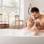 Young-man-helping-his-wife-to-take-bath
